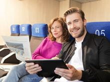 Couple sitting relaxing reading onboard our ferries